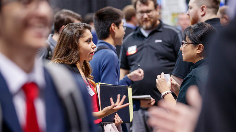 Student talking with employer at career fair