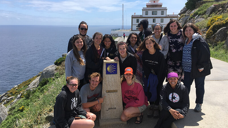 Students posing by monument on Study Abroad trip